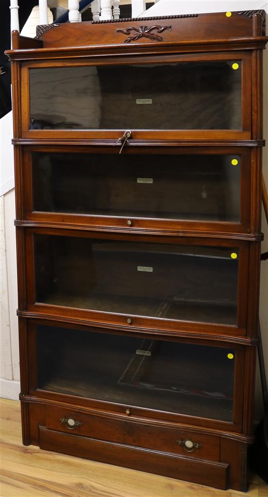 A Globe Wernicke serpentine mahogany four-section bookcase, c.1900, W.91cm